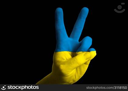 Hand with two finger up gesture in colored ukraine national flag as symbol of winning, victorious, excellent, - for tourism and touristic advertising, positive political, cultural, social management of country