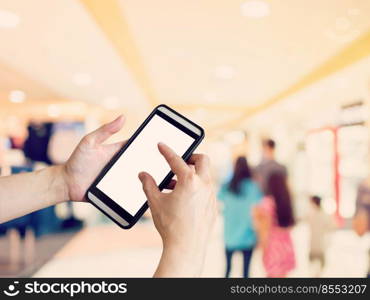 Hand woman holding and using phone with blurred background in shopping mall.