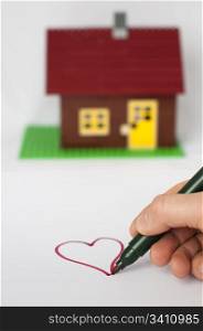 Hand write painting heart and house on background. Real estate conception