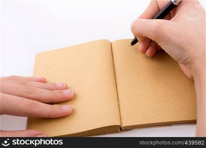 Hand writing on an empty notebook with a pen