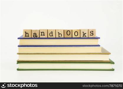 handbooks word on wood stamps stack on books, homework and academic concept