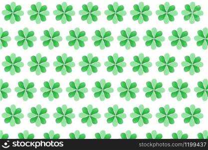 Handcraft shamrock&rsquo;s green plants pattern with four petals made from paper on a white background. Happy St.Patrick &rsquo;s Day concept.. Horizontal papercraft green background from leaves.