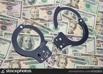 handcuff and dollar bank notes. crime in the economy.