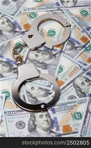 Handcuffs on money, crime or fraud concept