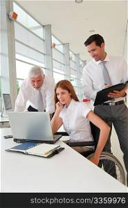 Handicapped woman attending a meeting in office