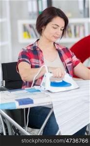 handicapped woman ironing the clothes