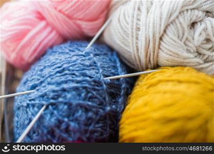 handicraft and needlework concept - close up of knitting needles and balls of yarn. close up of knitting needles and yarn balls