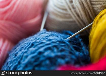 handicraft and needlework concept - close up of knitting needles and balls of yarn. close up of knitting needles and yarn balls