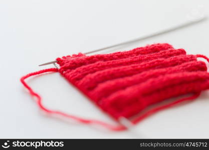 handicraft and needlework concept - hand-knitted item with knitting needles. hand-knitted item with knitting needles