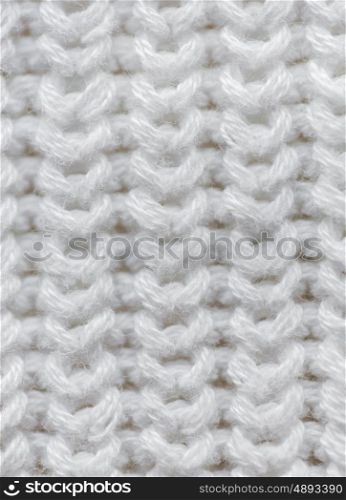 handicraft, knitwear and needlework concept - close up of knitted item