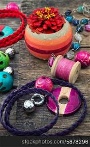 handicraft. Wooden beads and accessories for needlework on old wooden background