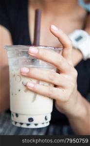 Handle Coffee Mug Hand holding a plastic cup containing coffee.