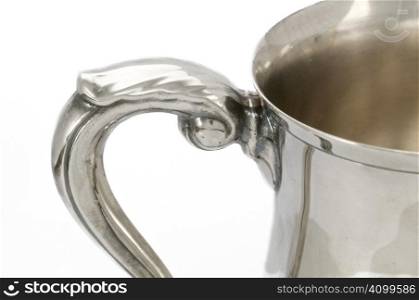 Handle detail on antique silver mug