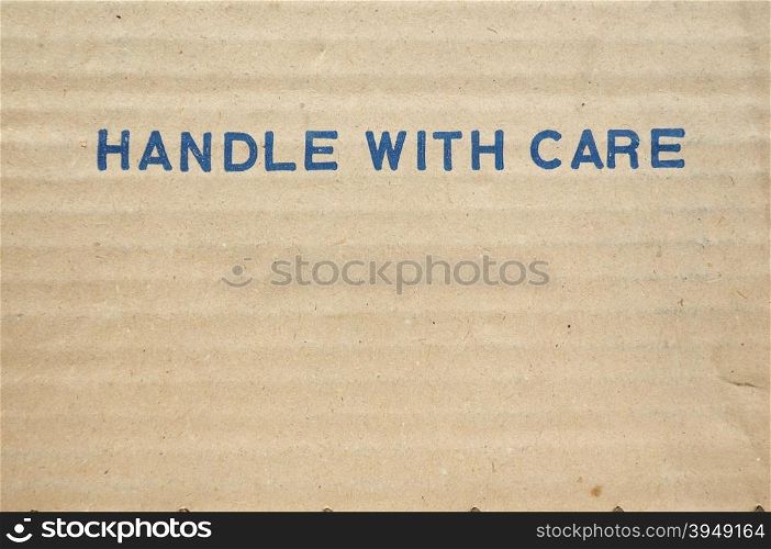 Handle with care. Handle with care tag on a corrugated cardboard packet
