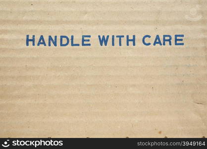 Handle with care. Handle with care tag on a corrugated cardboard packet