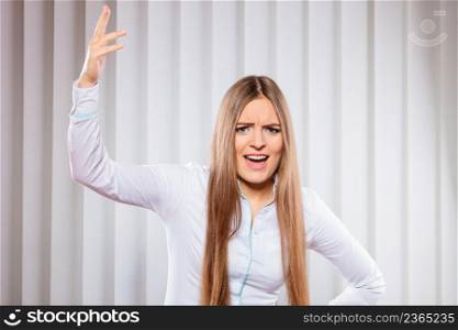 Handling stress and emotions in work. Frustrated female scream feel anger and irritation. Hands in air and open mouth. Formal dressed woman in office. Angry young woman bussines shout.