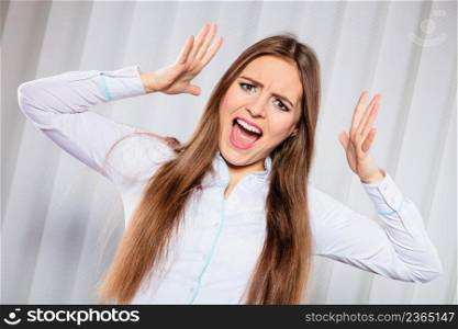 Handling stress and emotions in work. Frustrated female scream feel anger and pain. Hands in air and open mouth. Formal dressed woman with headache.. Angry young woman shout.