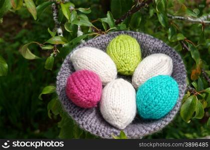 Handmade basket of egg, Easter symbol, traditional culture, closeup of egg on green background, knit gift from wool, to make decorative on holiday