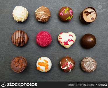 handmade chocolates. Colored chocolate candies sweets on a gray slate tray background