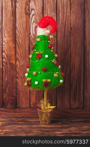 Handmade Christmas tree over wooden background, copy space