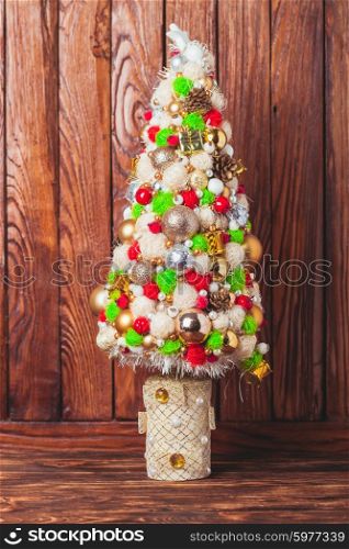 Handmade Christmas tree over wooden background, copy space