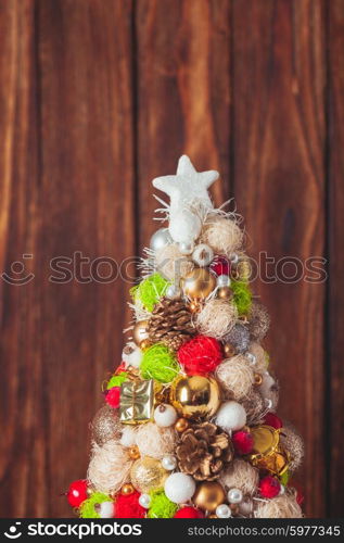 Handmade Christmas tree over wooden background, copy space