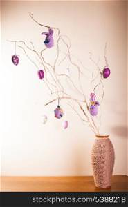 Handmade crochet easter decorations on the branches in vase