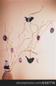 Handmade easter decorations on the branches in vase. Handmade easter decorations