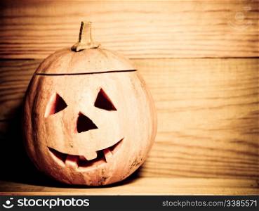 Handmade Halloween pumpkin on wooden background. Autumn holidays concept