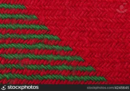 Handmade knit green and red background. Close up structure of the yarn. Christmas colors