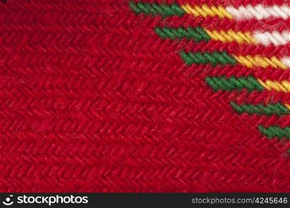 Handmade knit green and red background. Close up structure of the yarn. Christmas colors