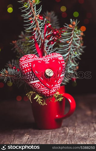 Handmade knitted heart - christmas decoration on the fir branch