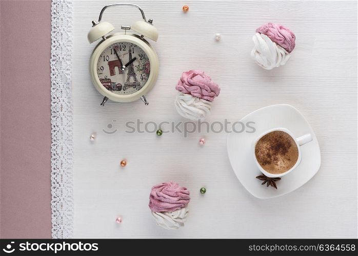 handmade marshmallows near a Cup of coffee and watch the alarm on the lace