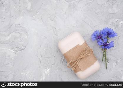 Handmade natural soap decorated with craft paper, scourge and blue flowers. Organic cosmetics concept. Top view Flat lay Copy space Template for design.. Handmade natural soap decorated with craft paper, scourge and blue flowers. Organic cosmetics concept. Top view Flat lay Copy space Template for design