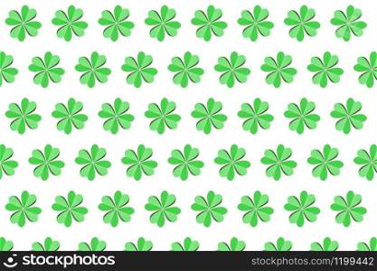 Handmade paper creative pattern from colored green shamrock&rsquo;s leaves with four petals on a white background. Happy St.Patrick &rsquo;s Day concept.. Handcraft pattern from green petals of natural shamrock.