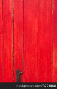 Handmade red painted old wooden door with door lock