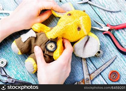 Handmade toy elephant. Process of making a soft elephant toy and working tool