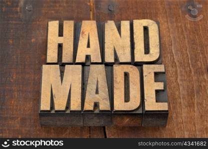 handmade word in vintage letterpress type on grunge wooden background with nails