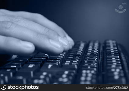 Hands above the keyboard. On a dark background, the black keyboard