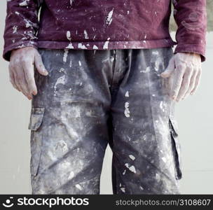 hands and white dirty trousers detail of plastering painter man