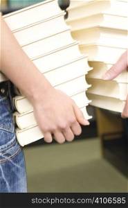 Hands carrying books