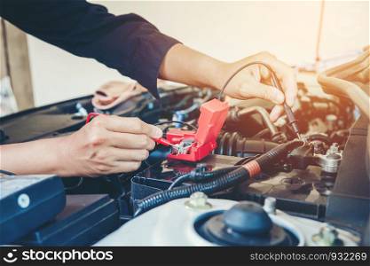 Hands check battery car mechanic working in auto repair service