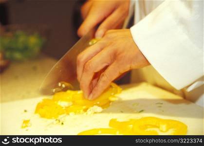 Hands Chopping a Pepper