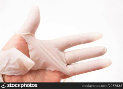 Hands close-up in torn rubber gloves. torn medical gloves after a working day