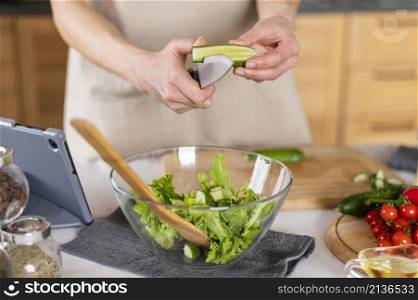 hands cutting cucumber kitchen