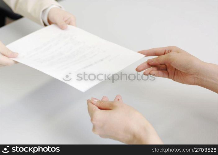 Hands delivering a contract