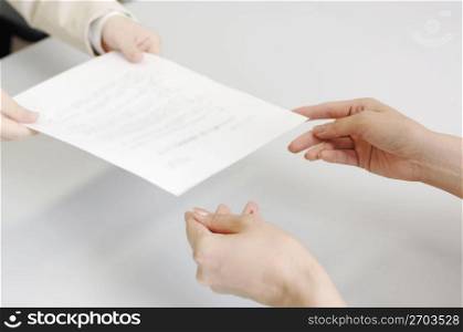 Hands delivering a contract