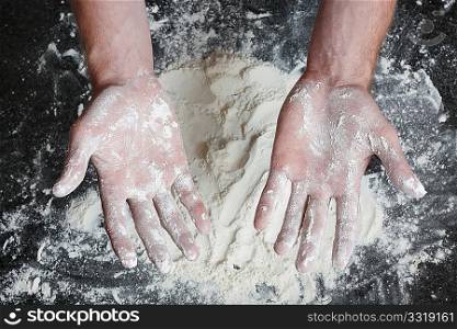 Hands dirty with white flour after preparing