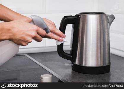hands disinfecting kettle