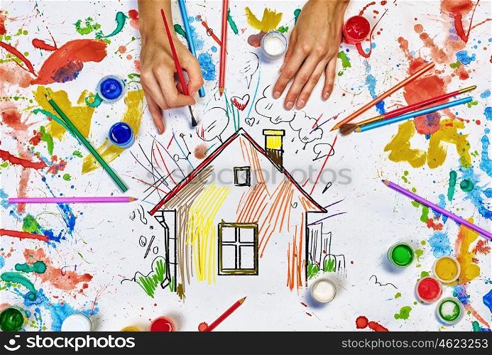 Hands draw house. Top view of hands drawing house colorful concept